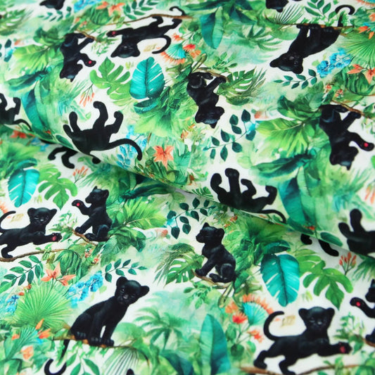 Baumwolljersey mit schwarzem Panther und grünem Dschungel-Design, bunte Blätter und Pflanzen Muster.