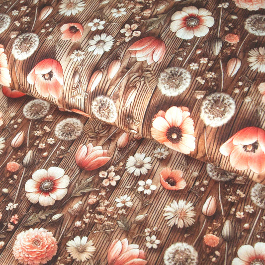 Baumwolljersey in Beige mit bedruckten Feldblumen und Pusteblumen im Landhausstil.